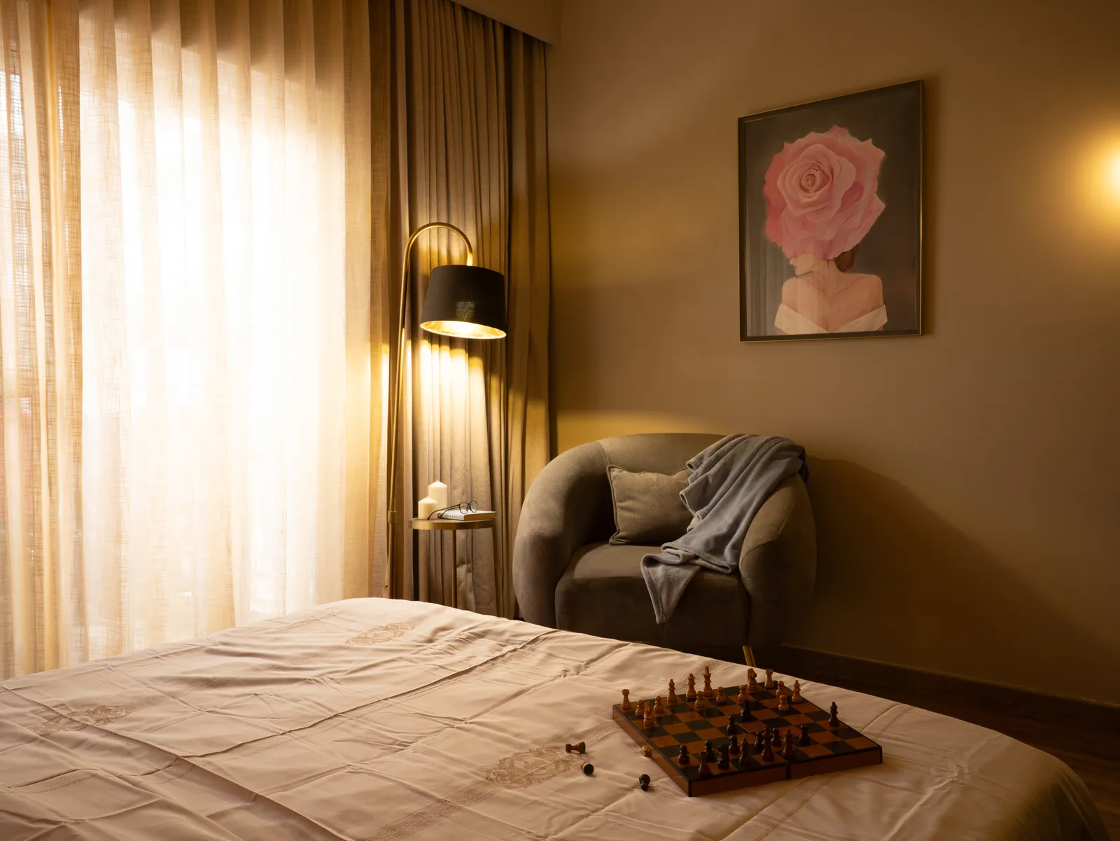Bedroom with armchair, floor lamp and framed rose painting — Amlan's Residence